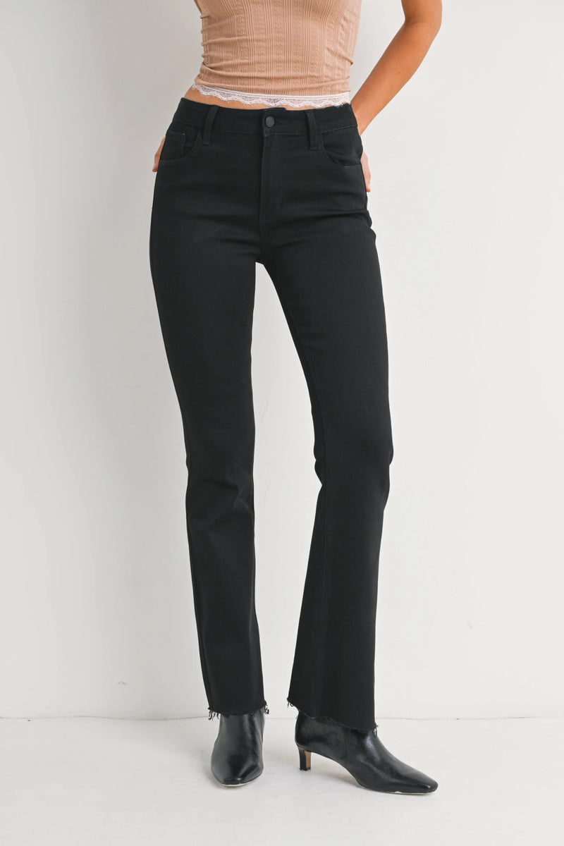 Mid rise flare denim jeans featuring black flared trousers with raw hem detail