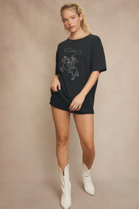 Black graphic tee with white cowboy design featuring western line stitch detail