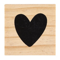 Black heart shape on wooden surface, highlighting TREASURE BOX EARRINGS design