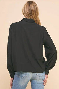 Black jacket with high collar and puffy sleeves over blue jeans, Woven Button style