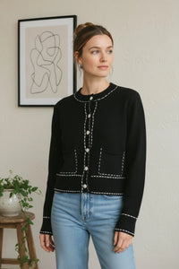 Black long sleeve accent stitch detail cardigan with white stitching and pearl buttons