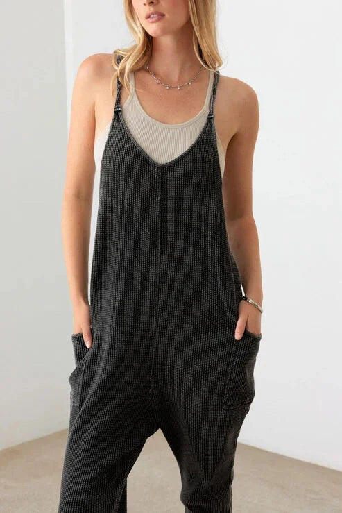 Black knit jumpsuit with pockets and thin straps, perfect for a boho, free spirit style