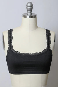 Seamless lace strap bralette revealing a black top with elegant lace detailing on the back