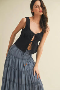 Scallop trim edge tie front sleeveless black lace-up corset top with tiered denim skirt