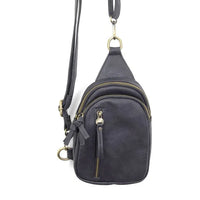 Black leather SKYLER SLING BAG with multiple zippered compartments and adjustable strap