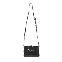Black leather ARIA RING BAG with gold ring accent and interior zip at its widest point