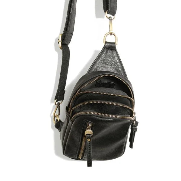 Black leather SKYLER SLING BAG featuring multiple zippered compartments