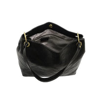 Black leather handbag with brass hardware from JEM BUCKET SHOULDER BAG, perfect for women’s boho chic clothing