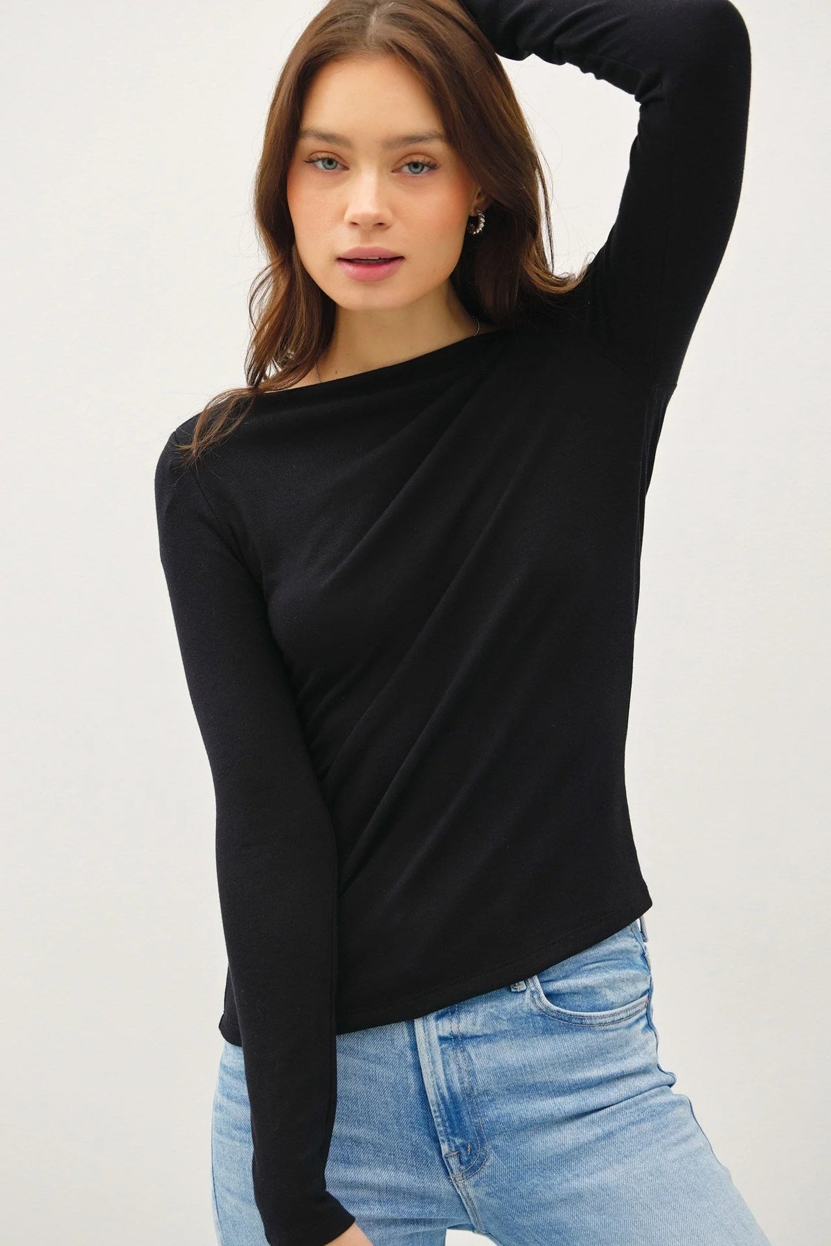 Black long sleeve knit top with basic boat neck and fitted silhouette for versatile style