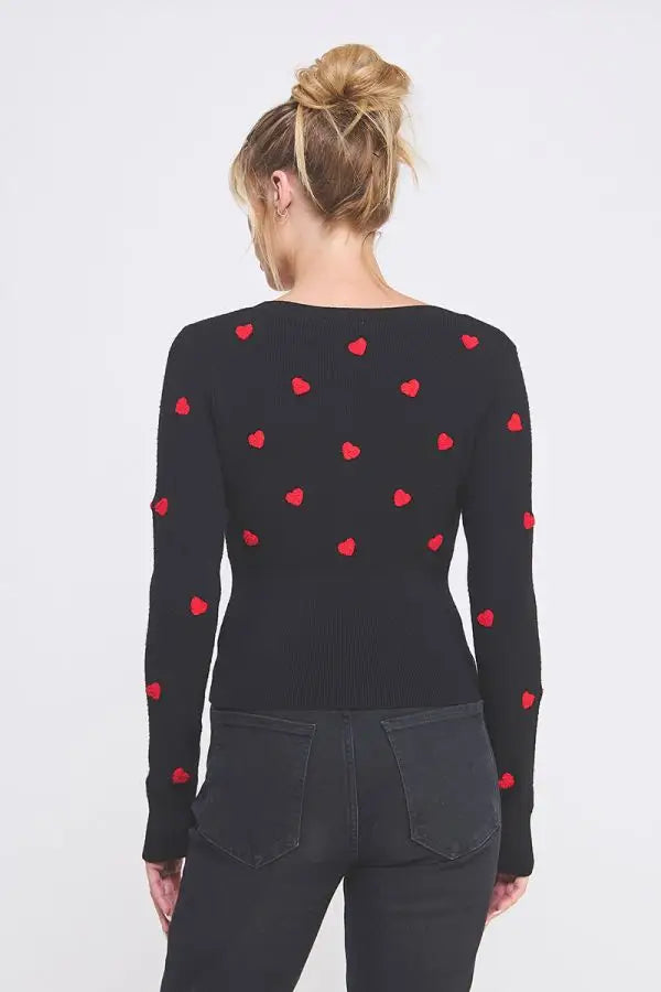 Black long-sleeved top featuring textured hearts from Shop Daisy’s women’s boho chic clothing