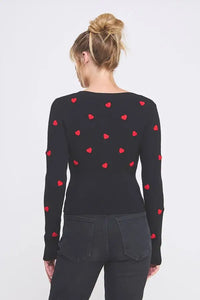 Black long-sleeved top featuring textured hearts from Shop Daisy’s women’s boho chic clothing