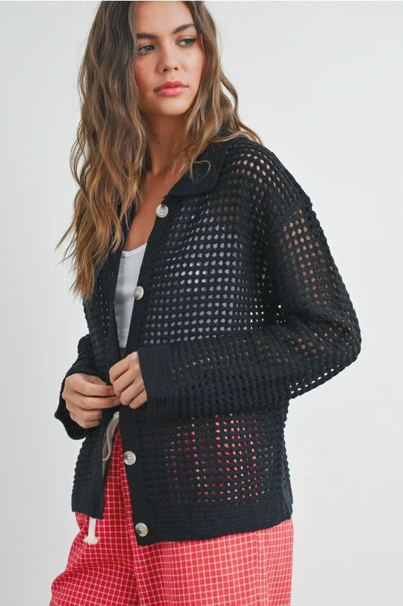 Open stitch crochet black mesh button-up cardigan over white top and red plaid pants