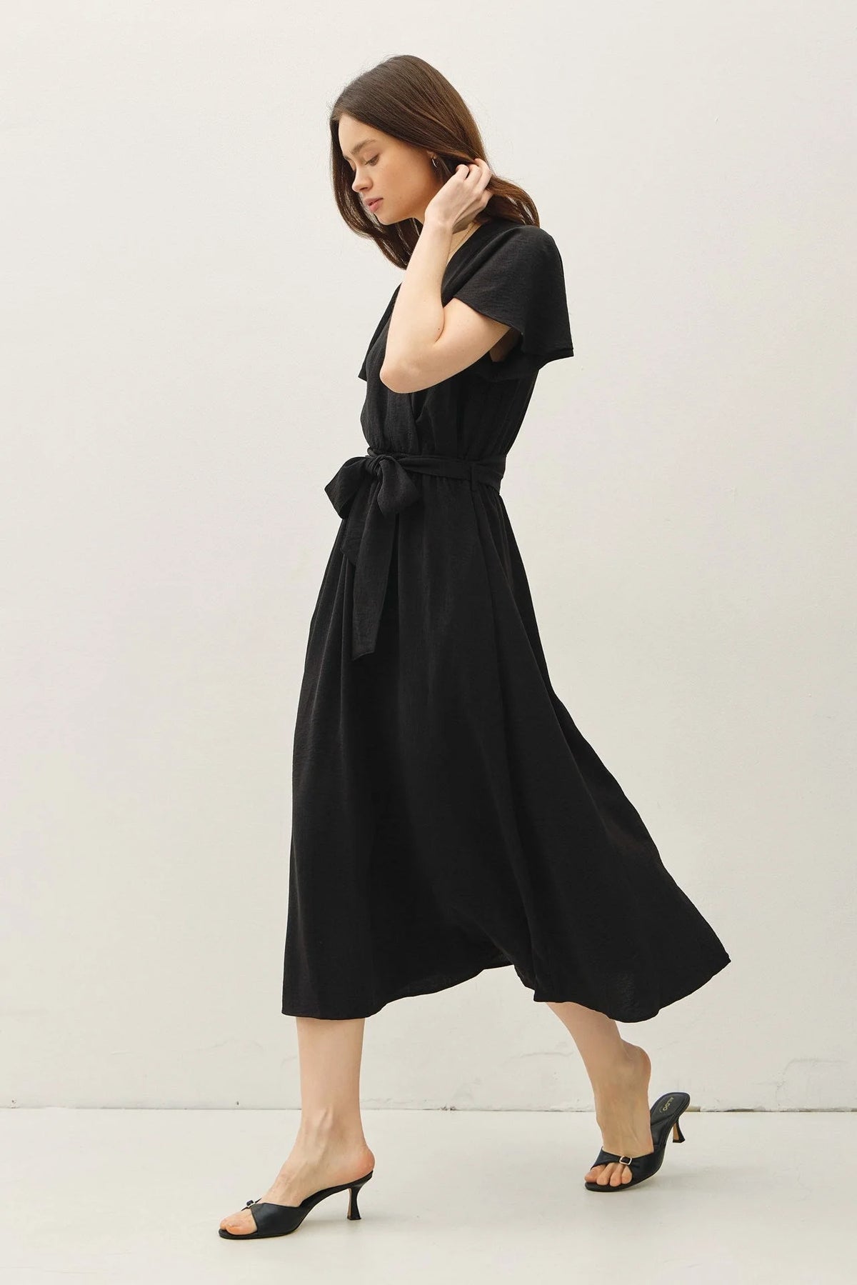 Black midi dress with ruffle cap sleeves and V neck tie waist for elegant style