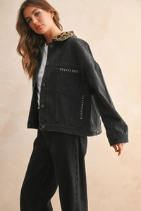 Black oversized denim jacket with leopard collar and white stitching details