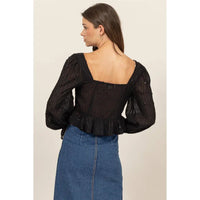 Black puff-sleeve blouse with ruffle trim, perfect for women’s boho chic clothing from Shop Daisy