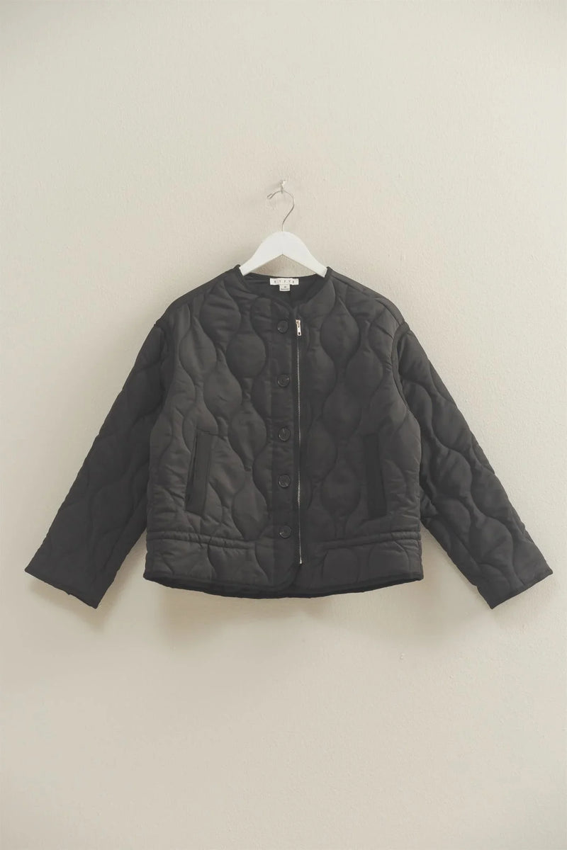 Black quilted peplum outerwear jacket with textured pattern and button closure