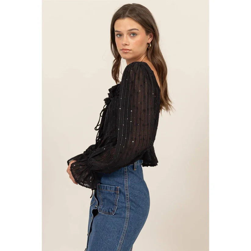 Black sheer blouse with ruffle trim and sparkly details from Shop Daisy’s women’s boho chic clothing