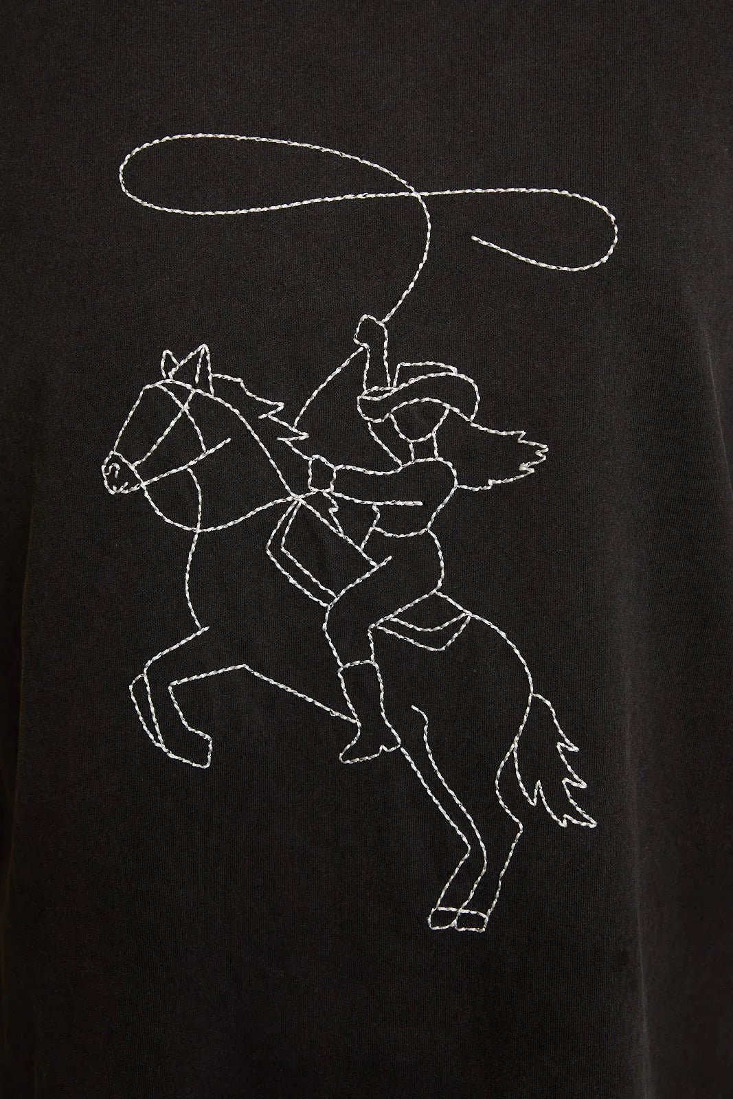Black T-shirt with white embroidered cowgirl on horseback showcasing western line stitch design