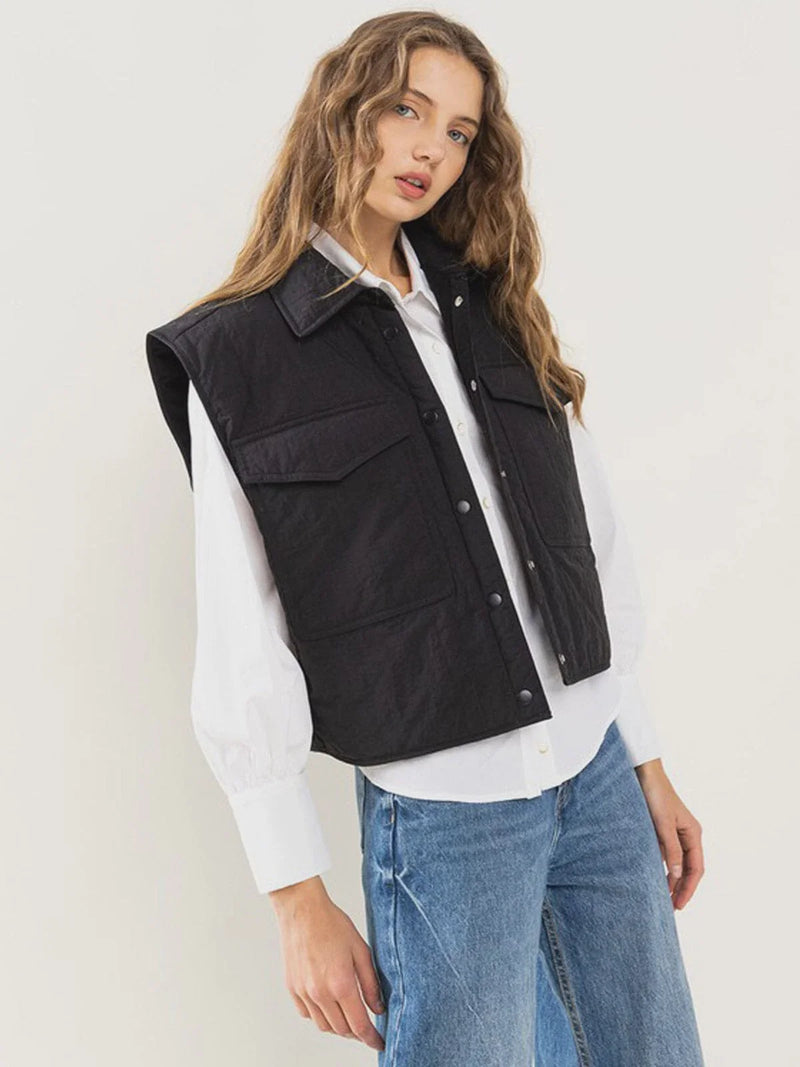 Black sleeveless denim vest over a white shirt, ideal for women’s boho chic clothing at Shop Daisy