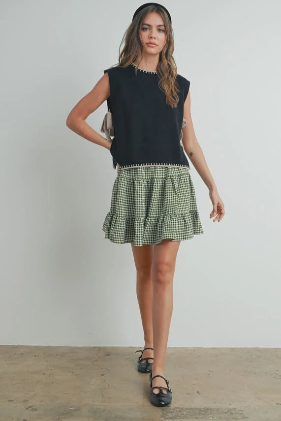 Mock neck sleeveless sweater in black top with green gingham ruffle skirt