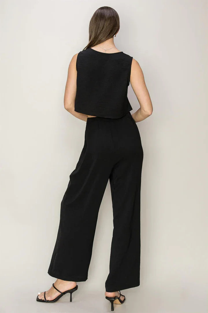 Black sleeveless jumpsuit with wide-leg pants for a flowy, free spirit look