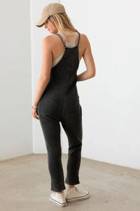 Black sleeveless jumpsuit with pockets, styled for a boho free spirit look