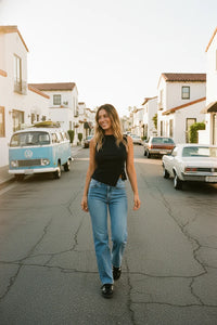 Black ribbed sleeveless top with mid rise straight leg denim jeans