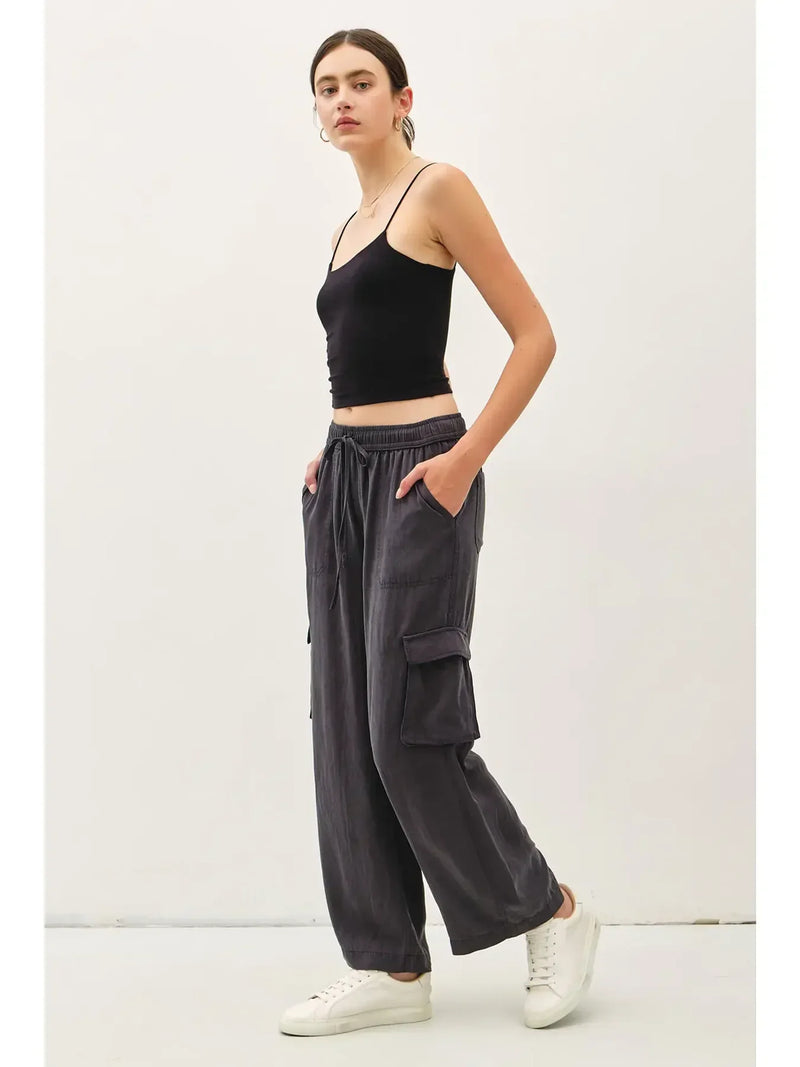 Black spaghetti-strap crop top with dark gray high rise drawstring wide leg cargo pants