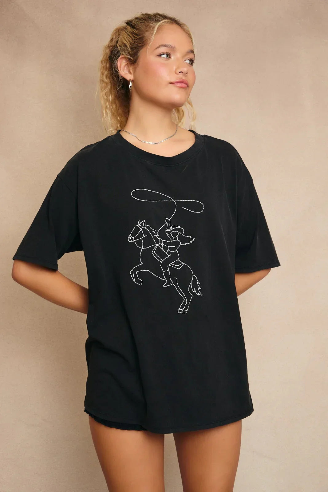 Black T-shirt featuring cowboy graphic with Western line stitch design for stylish Western wear