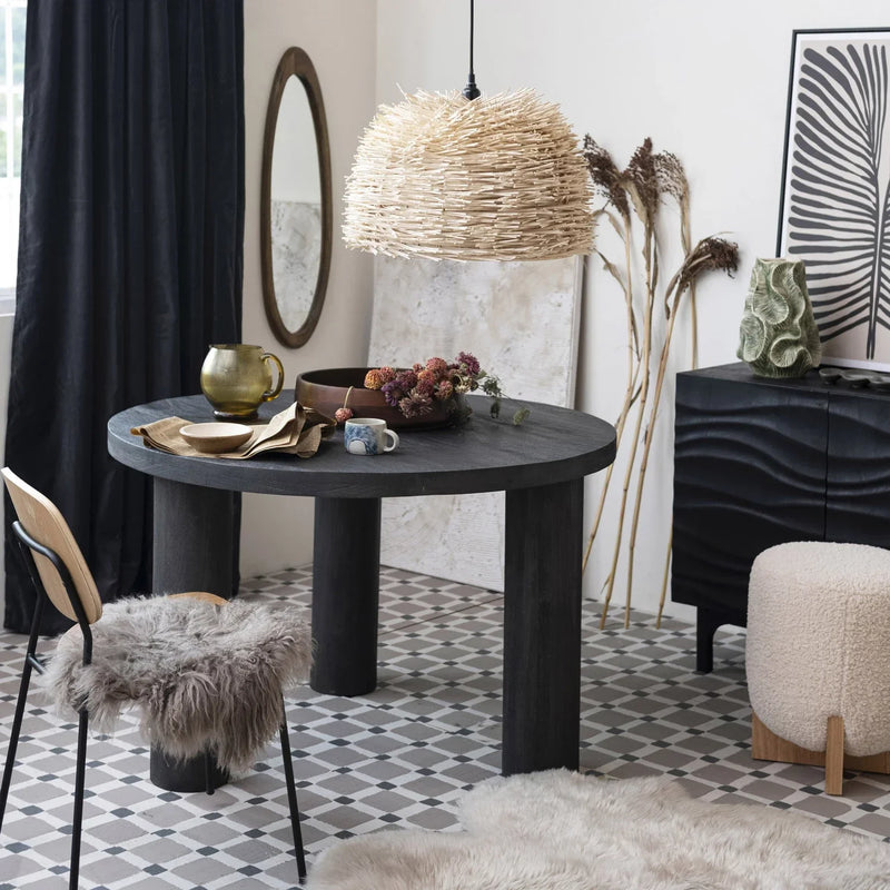 Black table showcasing a 2-1/2 quart fluted glass pitcher with a round mirror and white rug