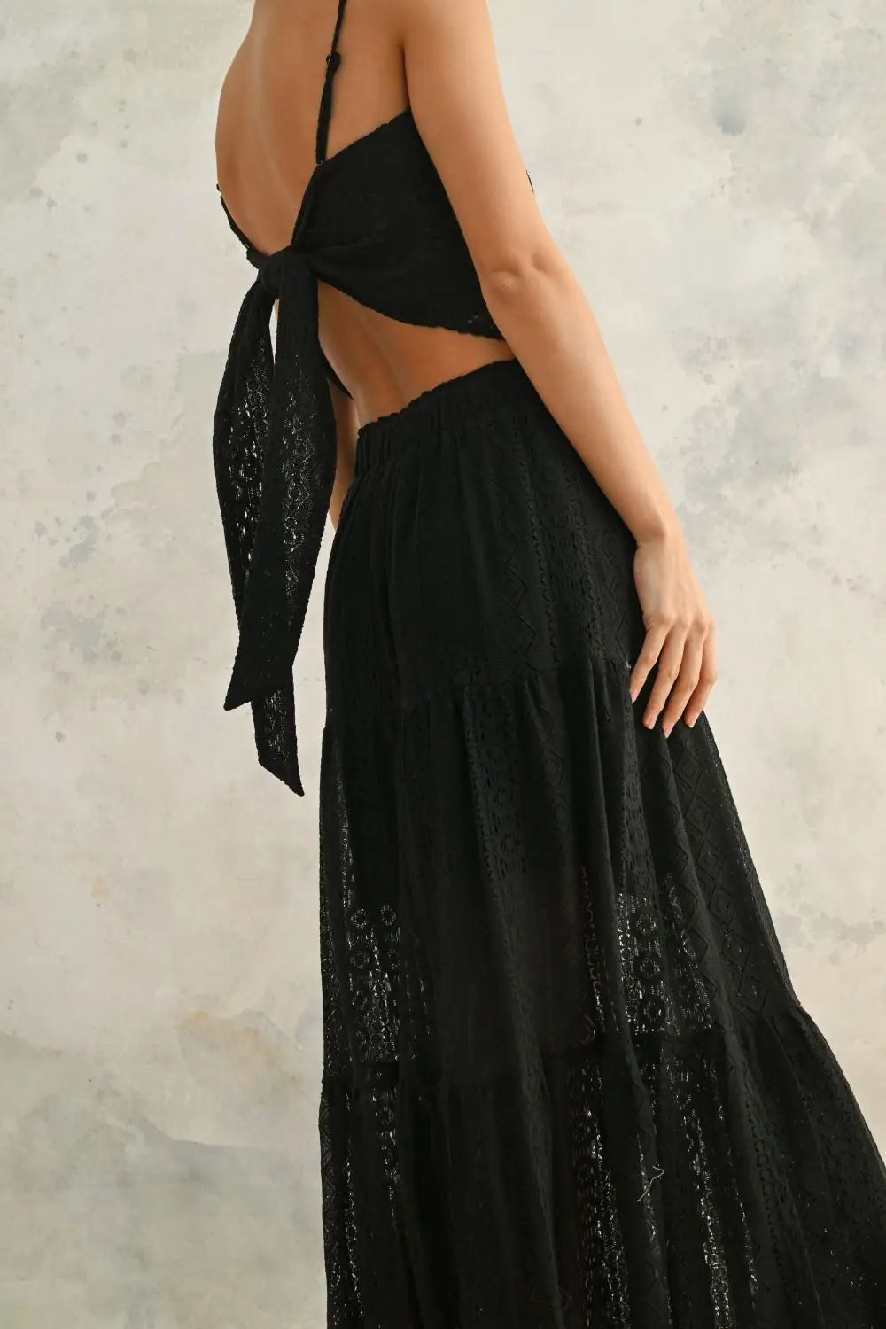 Black two-piece dress with tie back made of crochet lace fabric and a fabric tube handkerchief style