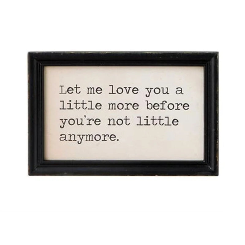 Black and white framed wall decor featuring the phrase let love you you’re you’re