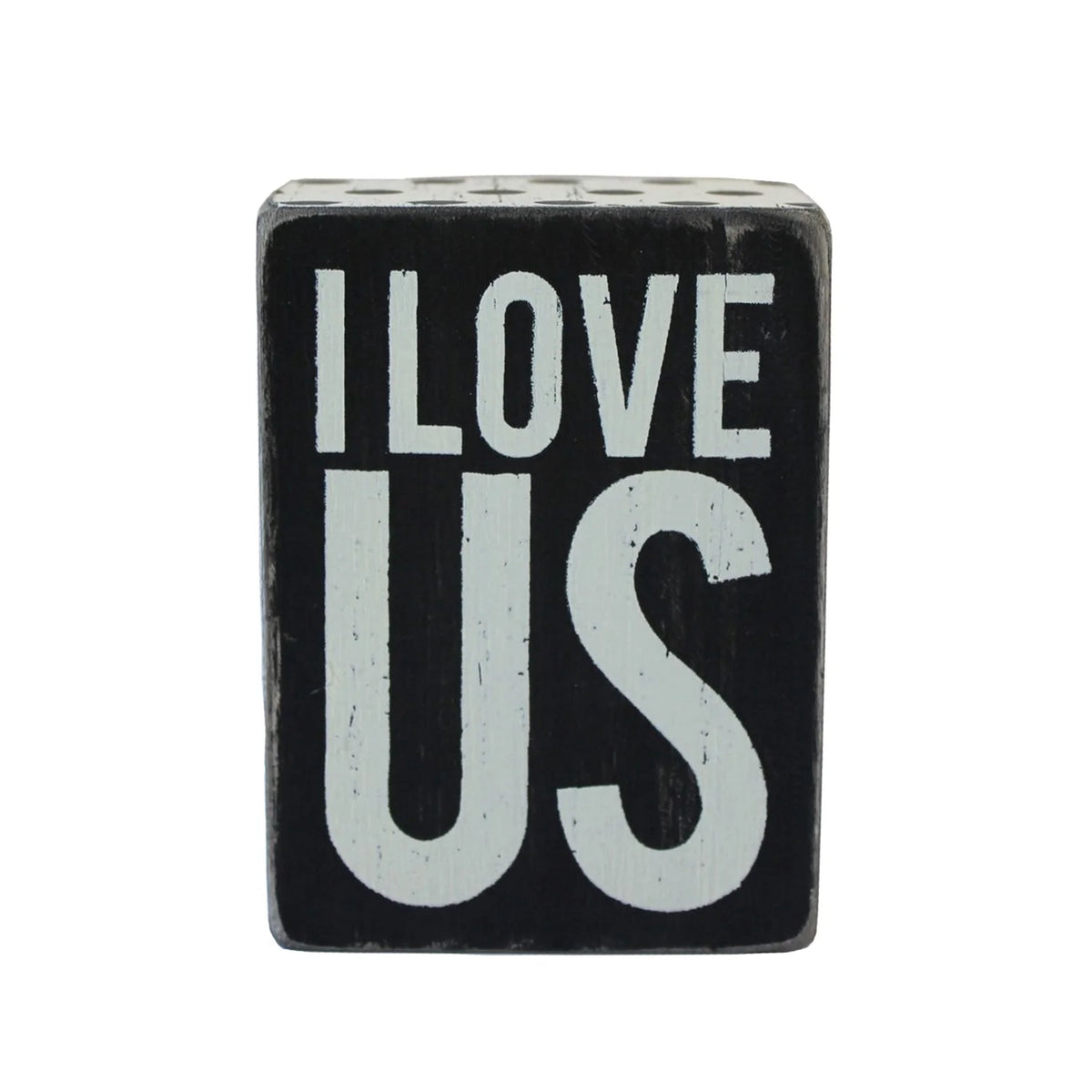 Black and white wooden box sign displaying the phrase Love Us in a stylish design