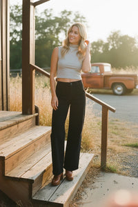 High-rise patch pocket wide leg flare denim jeans with brown leather boots