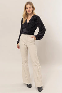 Black wrap-style top with balloon sleeves and beige wide-leg pants from Shop Daisy, womens boho clothes