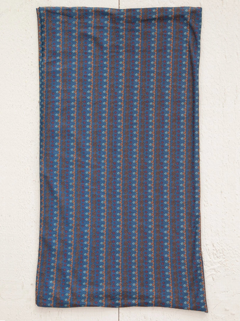 Blue and brown striped scarf hanging on a wall, ideal for a tube top or headband