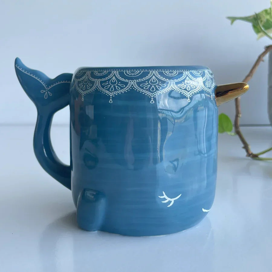 Blue ceramic Narwhal Folk Art Mug with whale tail handle and lace rim pattern