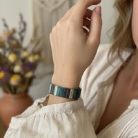 Earthy textured bohemian bracelet in blue green striped leather with silver accents