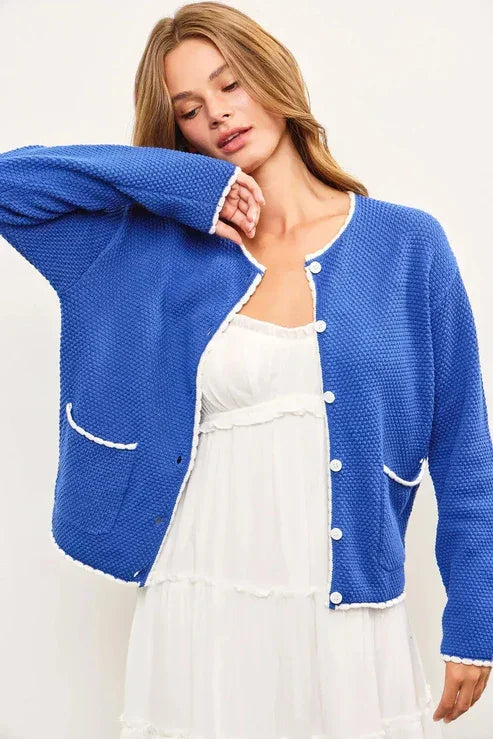 Blue knit cardigan with white trim from shop Daisy, perfect for women’s boho chic clothing