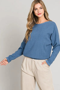 Blue long-sleeved sweater with round neckline featuring soft chevron pattern design