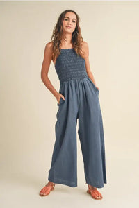 Blue smocked wide-leg jumpsuit from Shop Daisy, perfect for women’s boho chic clothing