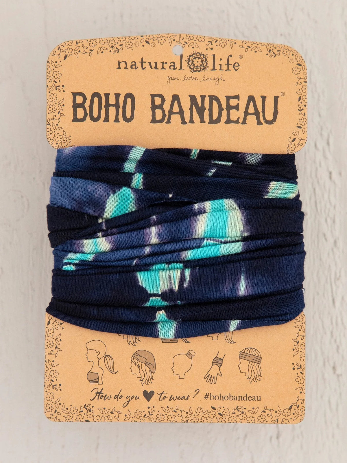 Blue tie tied to a card showcasing the Turquoise Navy Tie-Dye Boho Bandeau headwrap