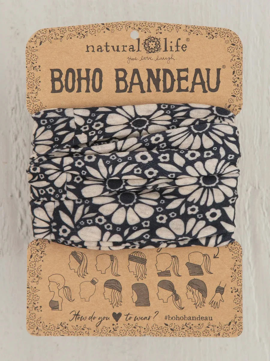 Boho bandeau headband in black and white daisies on a cardboard display, flowy style