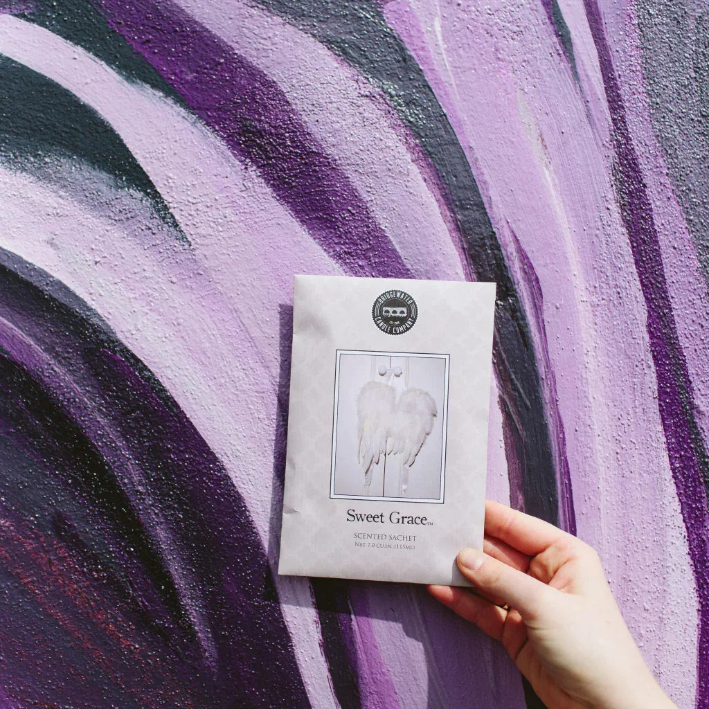 Person holding Scented Sachets Sweet Grace in front of a painted wall