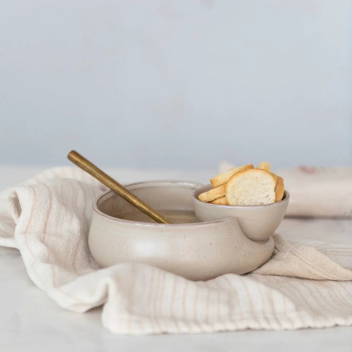 Bowl of homemade French onion soup in a STONEWARE CRACKER & SOUP BOWL with a spoon