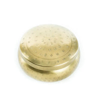 Brass finish round hammered container with textured dots on its surface