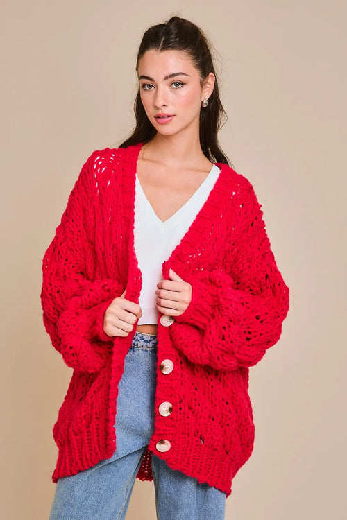 Bright red chunky sweater cardigan with white buttons and open-weave pattern