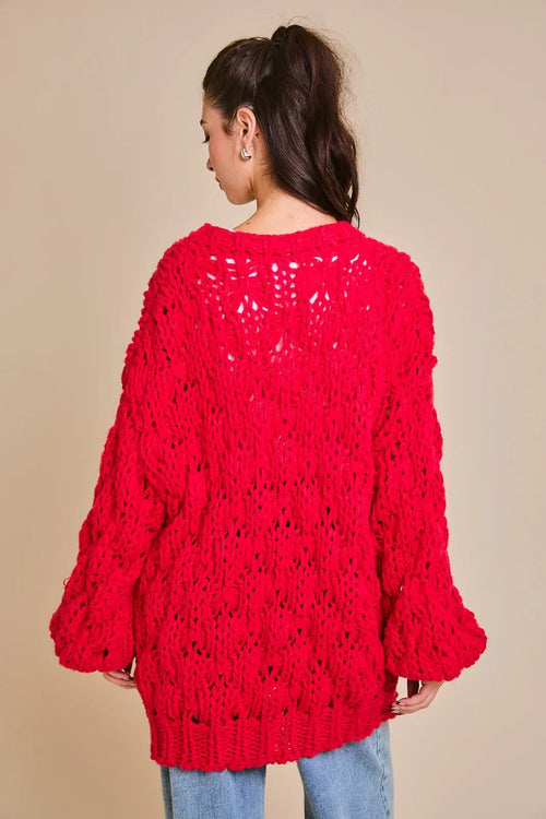 Bright red chunky sweater cardigan featuring an open lacey pattern and bell sleeves