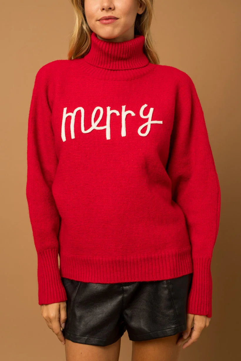 Bright red turtleneck sweater with merry text for women’s boho chic clothing at Shop Daisy