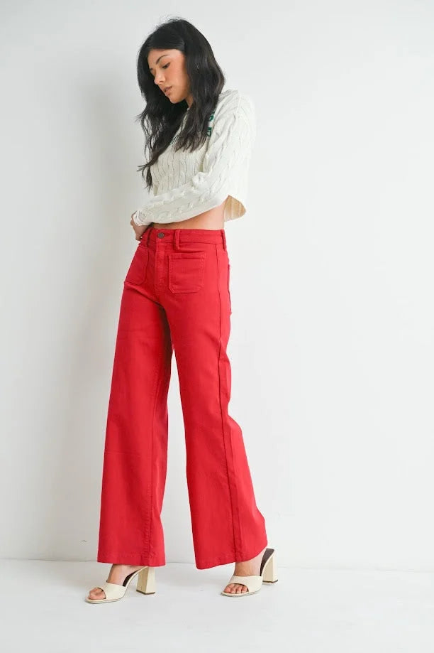 Bright red mini patch pocket wide jeans styled with a white top on a woman